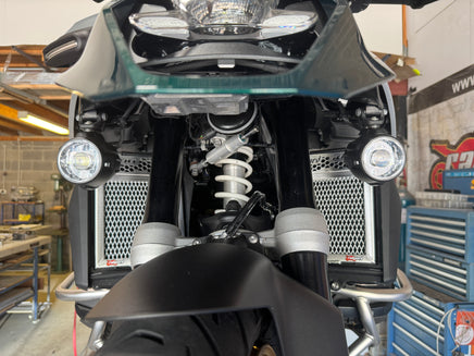Polished motorcycle radiator guards for a BMW R1300GS