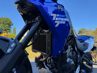 Blue Yamaha Tenere 700 motorcycle with clear blue sky in the background showing off a black Rad Guard fitted giving the radiator protection