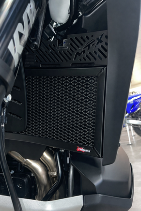Close-up of a motorcycle radiator guard with 'Rad Guard' branding in a showroom setting for a CFMoto 1000 mt-x