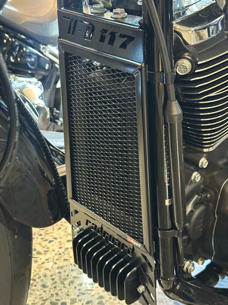 Close-up of a motorcycle radiator with visible branding of radguard for a Harley Davidson Heritage Classic 117 in the powder coated black