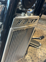 Close-up of a motorcycle radiator guard with HD 117 text showing the protection you need