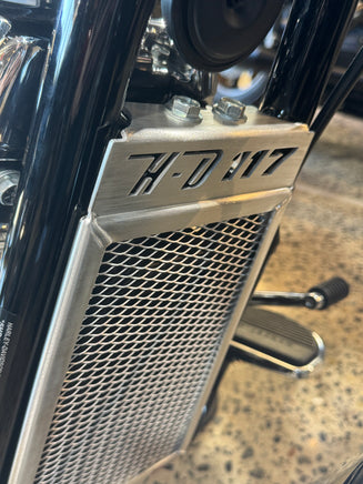Close-up of a motorcycle radiator guard with HD 117 text showing the protection you need