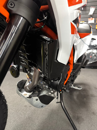 Close up and side view of the KTM 390 Enduro R fitted with a Rad Guard radiator guard fitted in black. 