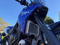 Close-up of a blue motorcycle with 'TENERE 700' branding against a clear sky - showing the Rad Guard radiator guard protecting what needs the most protection.
