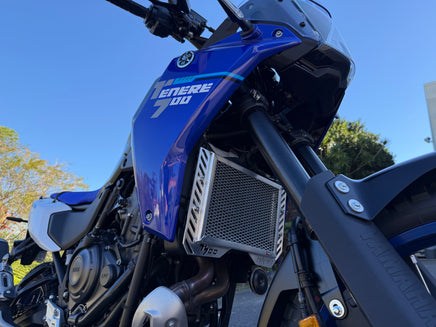Close-up of a blue motorcycle with 'TENERE 700' branding against a clear sky - showing the Rad Guard radiator guard protecting what needs the most protection.