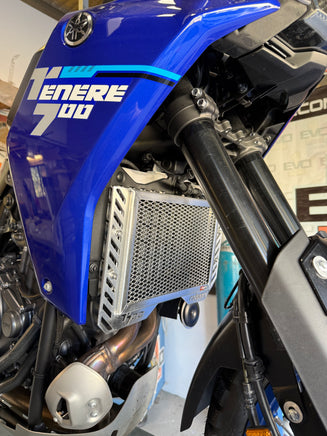 Close-up of a motorcycle radiator and blue fender for a Yamaha T700 Tenere showing a polished alloy Radiator Guard fitted to give protection
